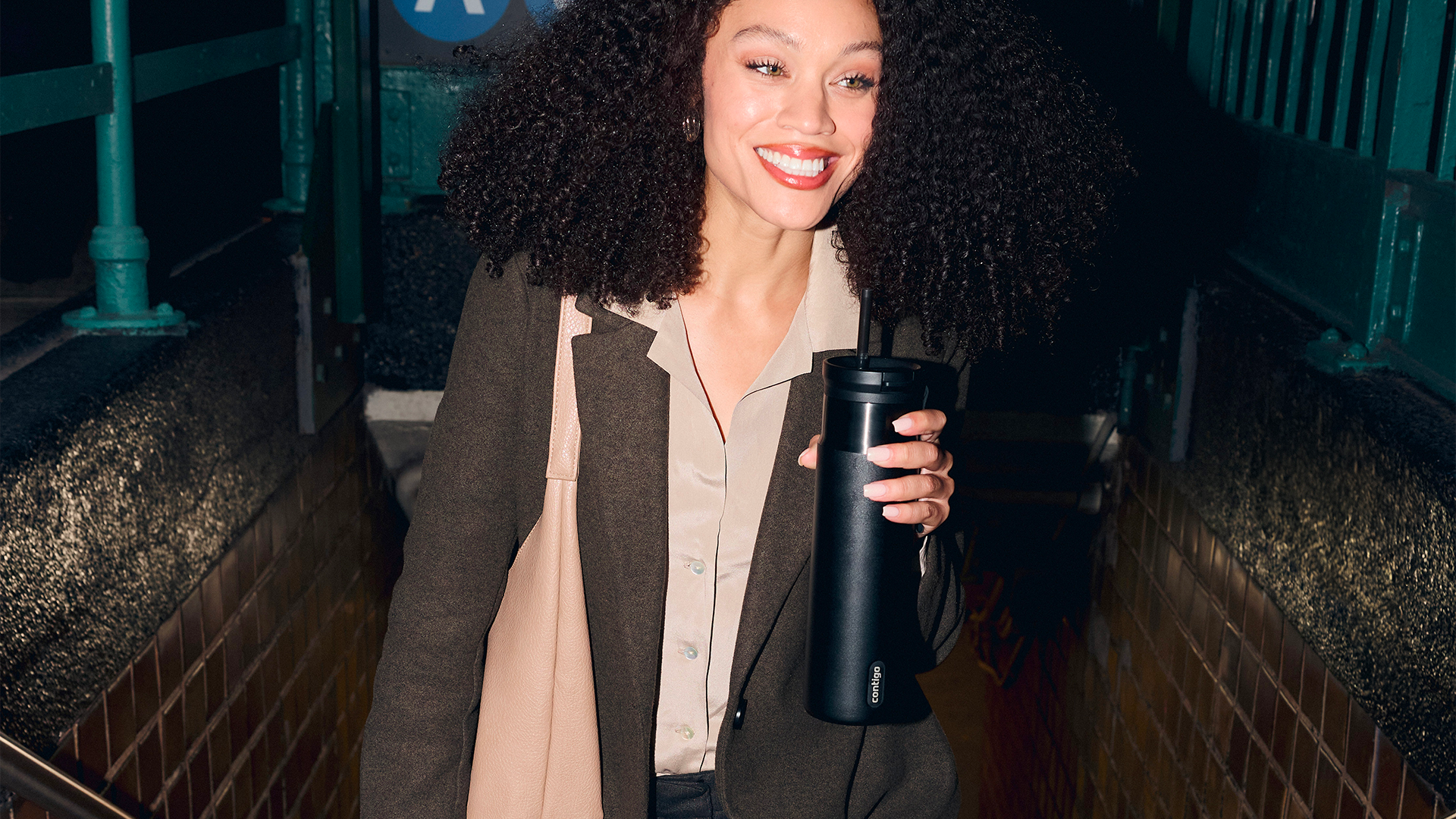 Woman carrying a black Contigo bottle